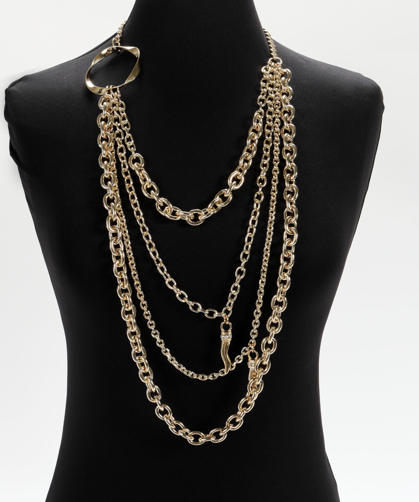 CLIPS Long Gold Four-Strand Necklace with Central Ring and Decorative Pendants”